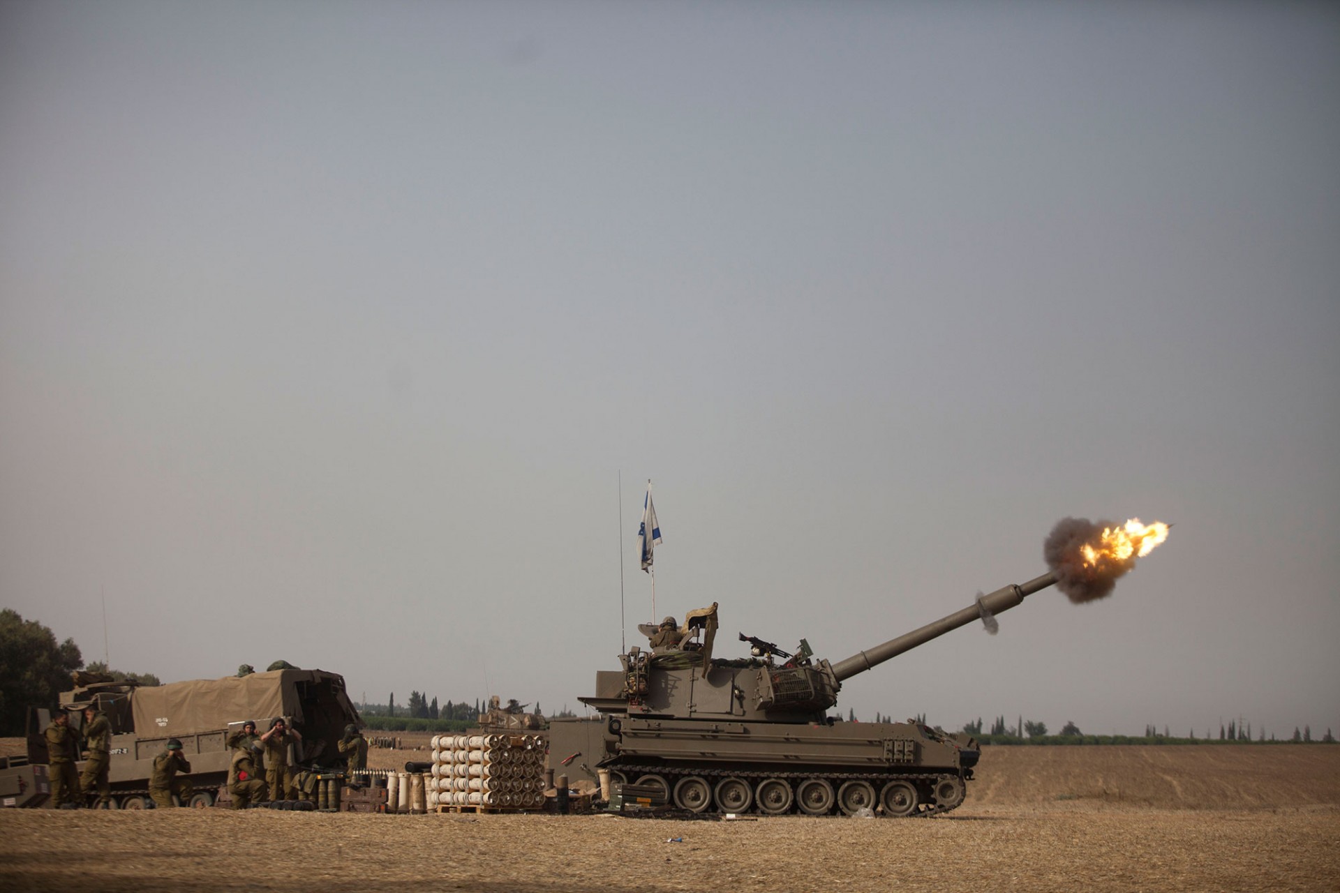 An Israeli artillery cannon fires a shell on July 12, 2014 on Israel's border with the Gaza Strip.